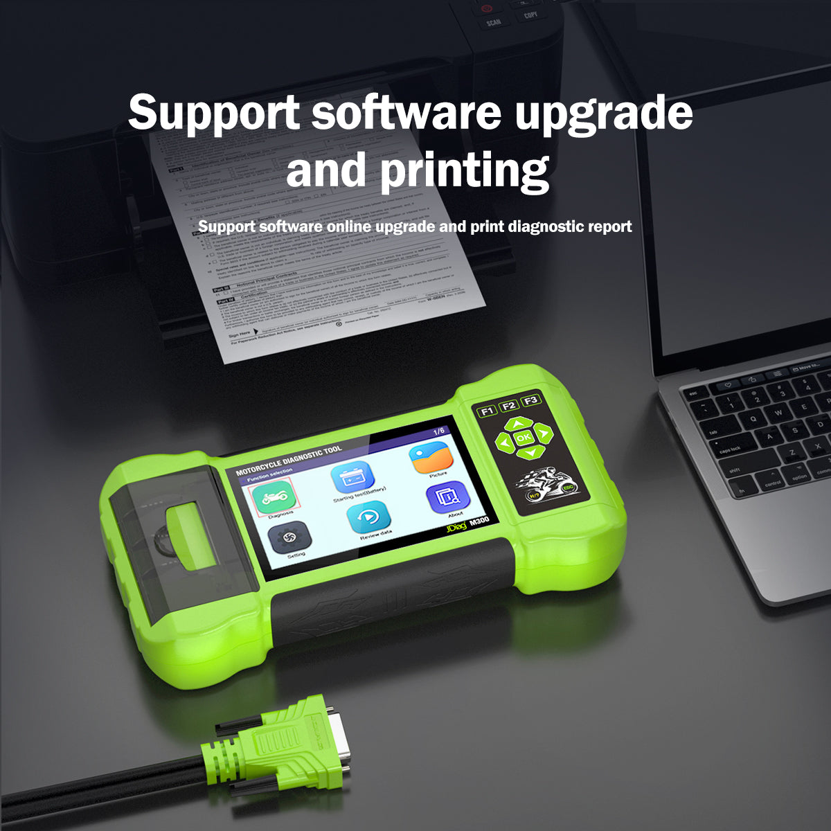Light-green JDiag M300 motorcycle diagnostic scanner connected beside a laptop and report printer